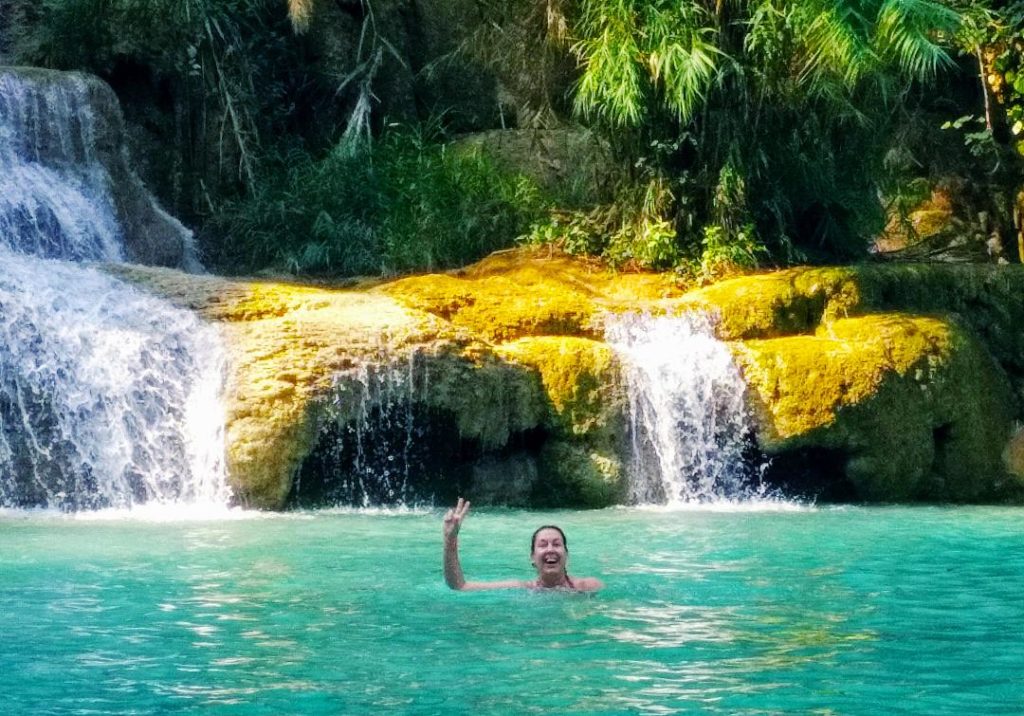 Frau im Becken eines Wasserfalls